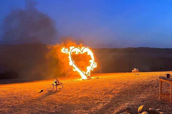 Heart-shaped fire performance in the Agafay desert at night