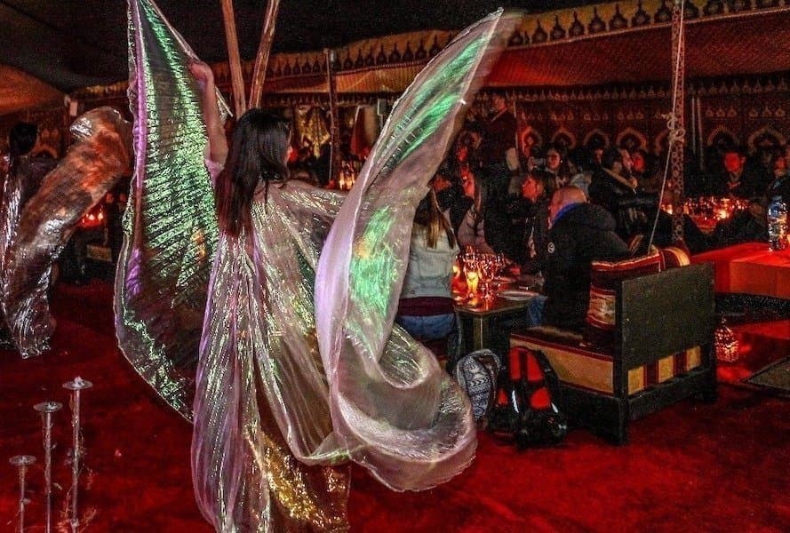 Oriental dancer with illuminated wings during an Agafay evening