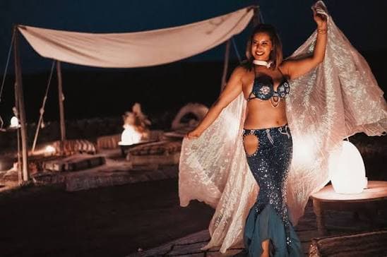 Oriental dancer performing under an Agafay camp tent