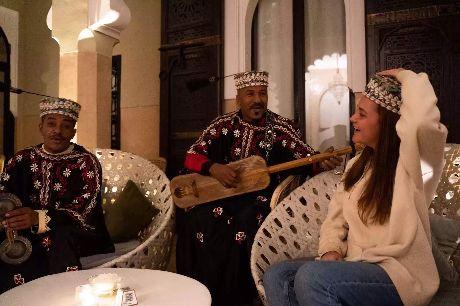 Gnaoua musicians performing beside guests during dinner