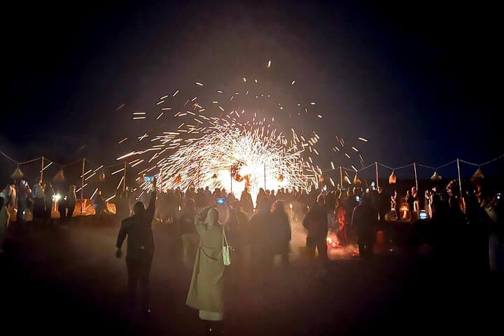Guests watching a live fire performance during an Agafay dinner show