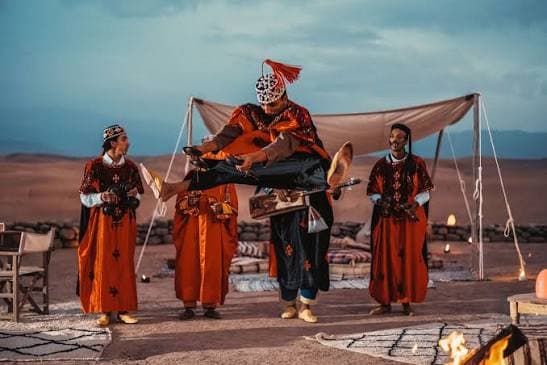 Gnaoua troupe performing outdoors in the Agafay desert